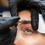 young woman getting beauty treatment her eyebrows